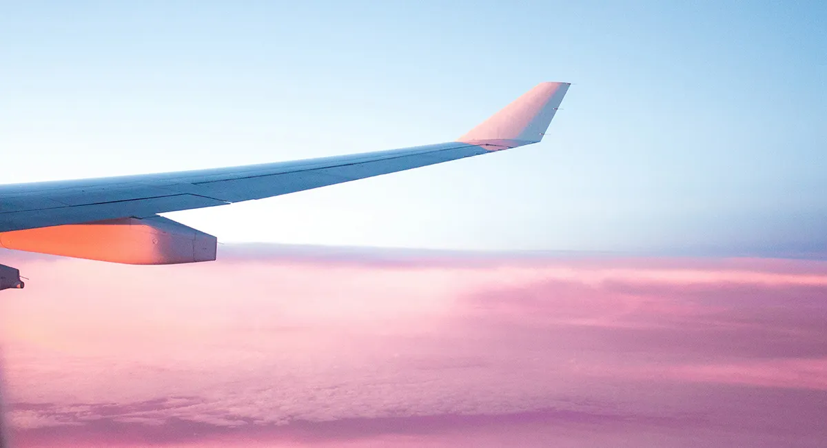View of plane wing above clouds